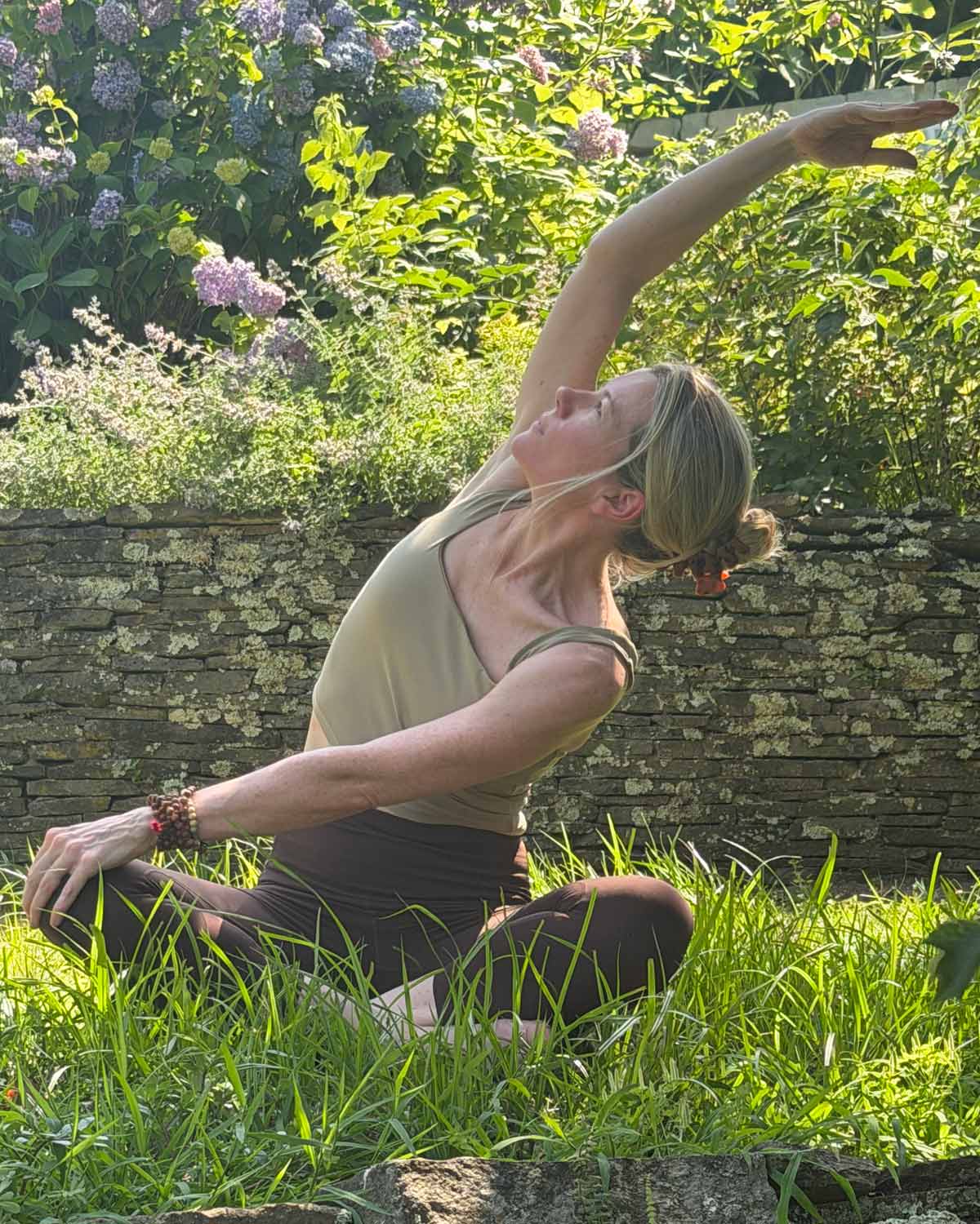 Tara Farrell in a standing side stretch
